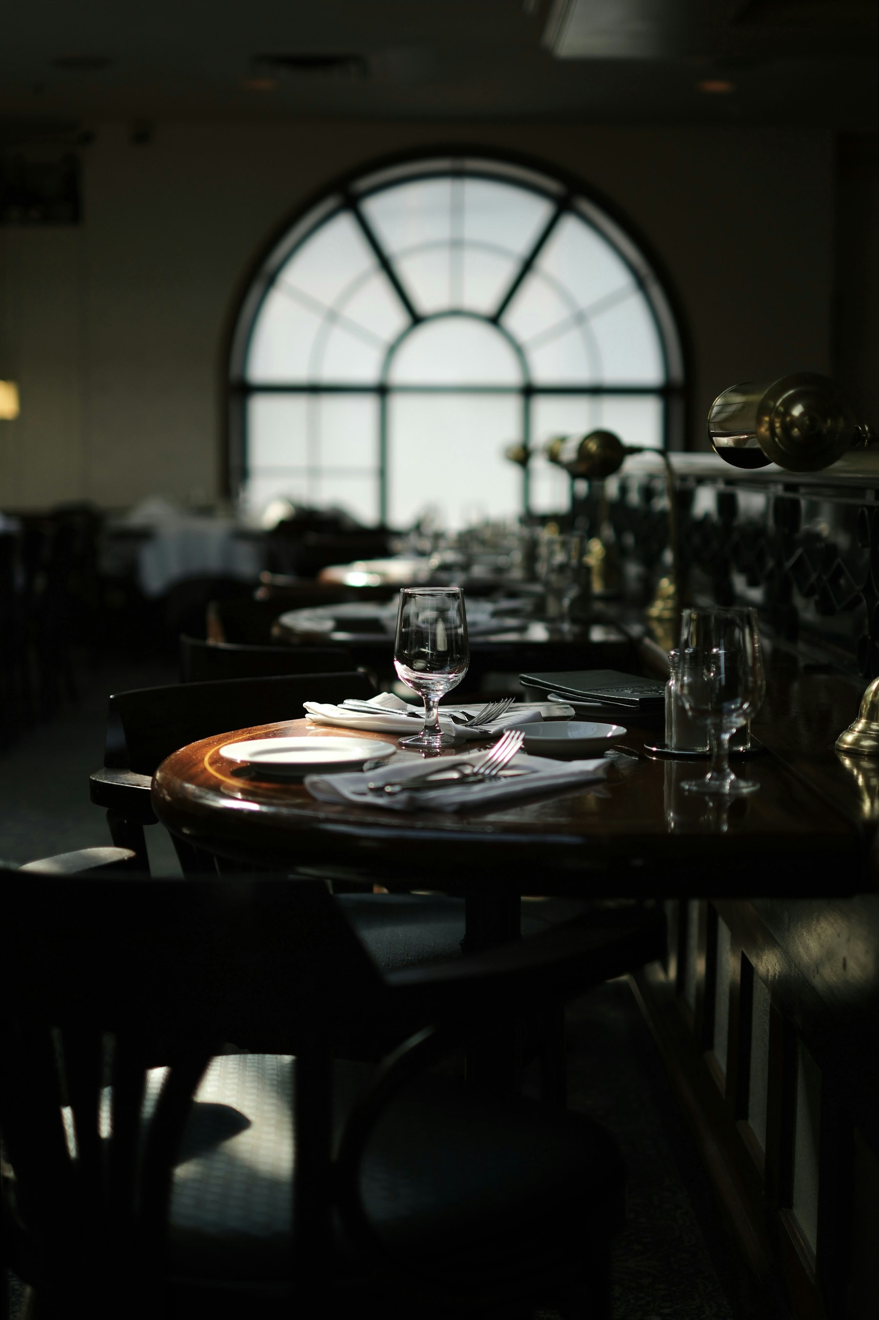 Restaurant tables set with glasses and tableware